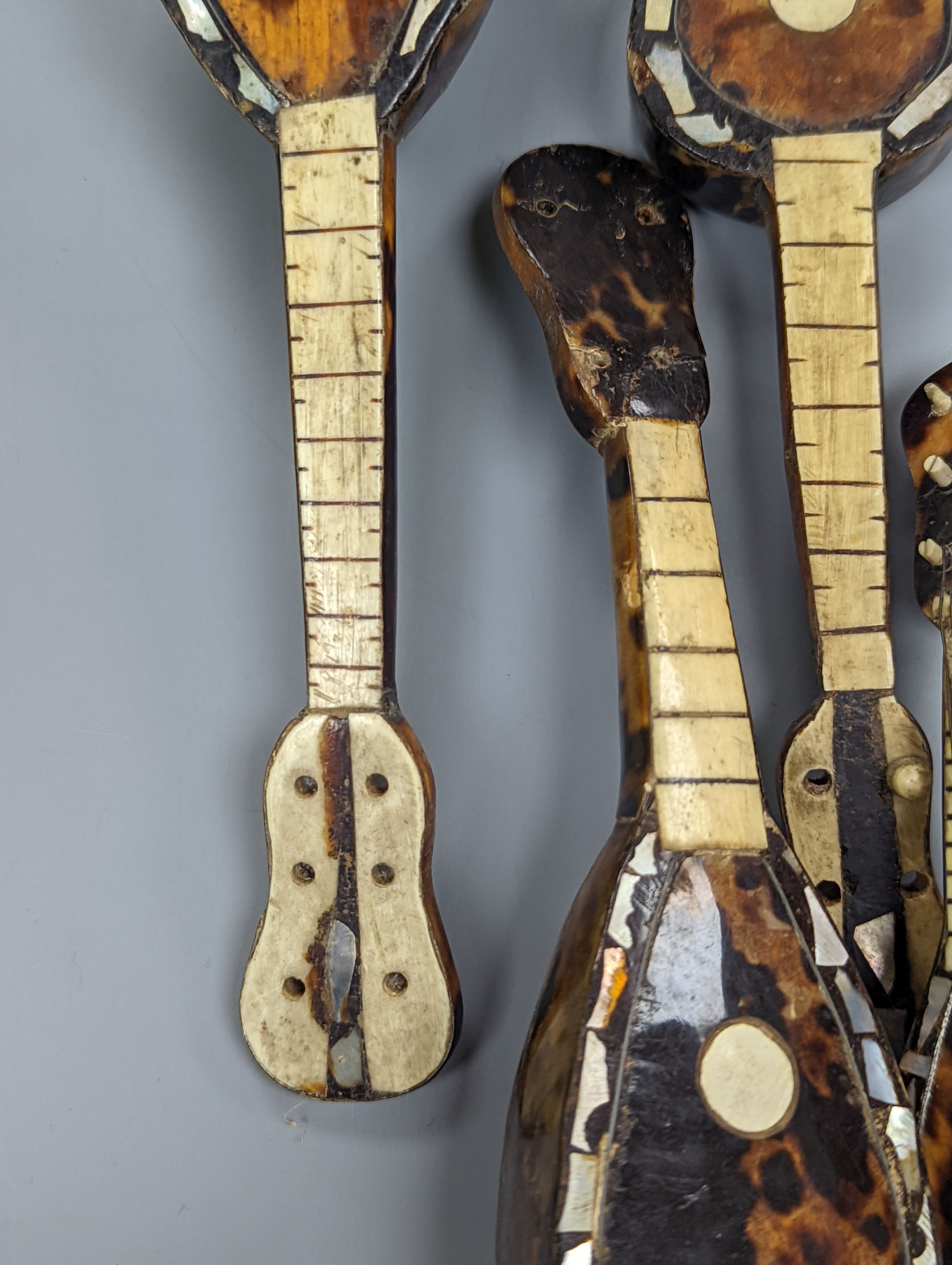 Five 19th century tortoiseshell miniature stringed instruments, longest 20cm.